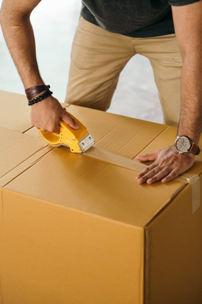 crop-man-sealing-box-with-scotch-tape-4247766 Unrecognizable man sealing box with duck tape while preparing for moving out